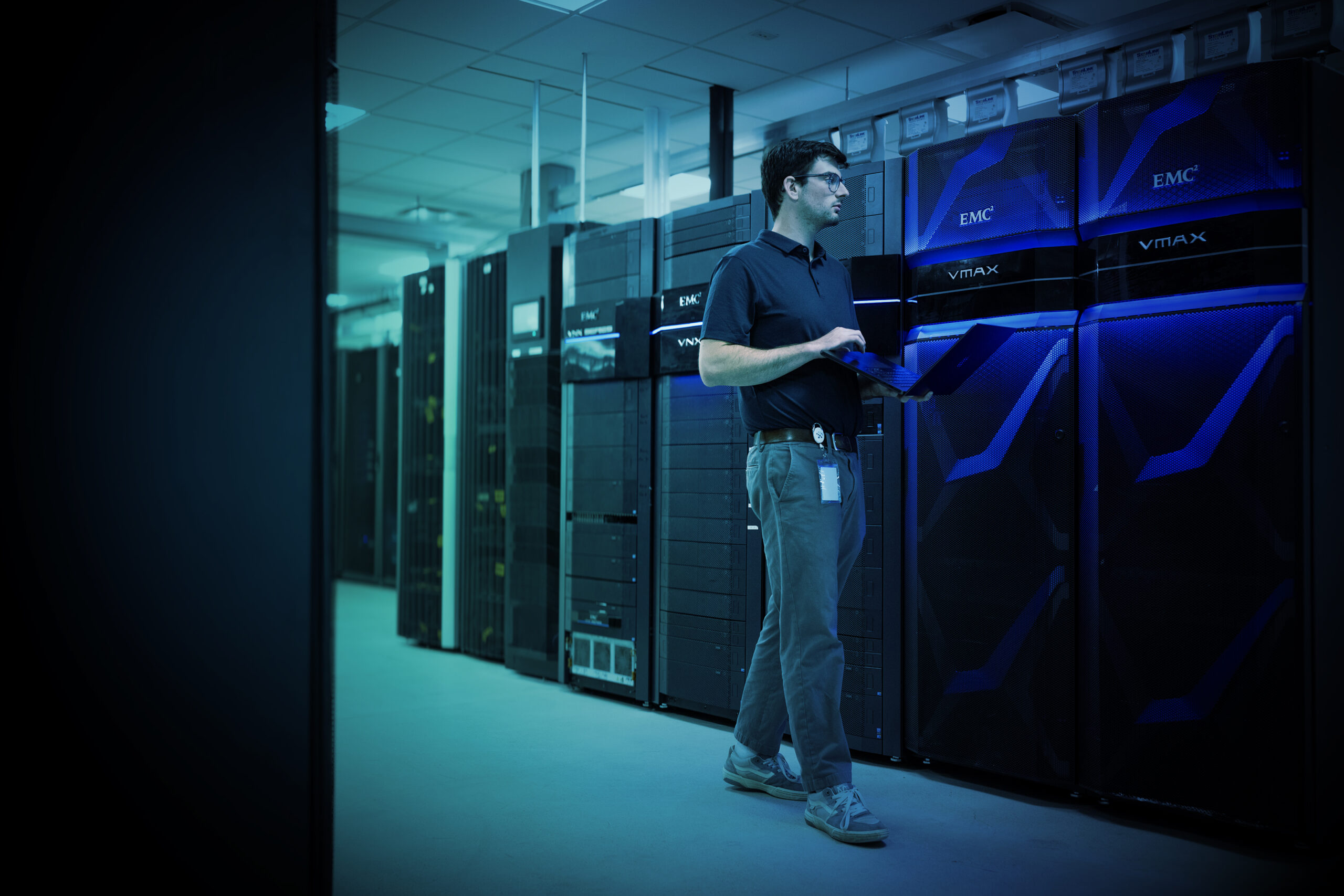 man walking around a data center providing IT hardware maintenance